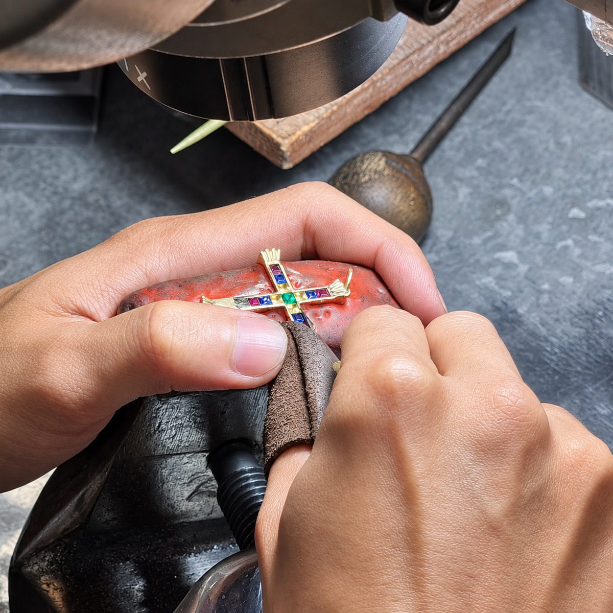 Stone setter setting coloured gemstones by hand at the Casa Jewels workshop in Bangkok